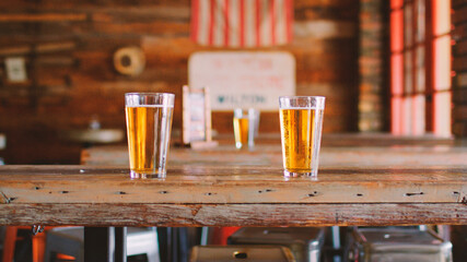 Glasses Of Beer On Table In Empty American Sports Bar