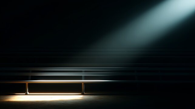 Light beams illuminate an empty bench in a dimly lit arena at dusk