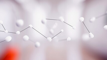 A close-up, abstract view of interconnected white spheres linked by thin black lines, set against a softly blurred background.