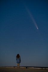Silhouette of a Young Woman Against the Starry Sky, Observing the Celestial Event: Rare Comet ATLAS 2024 Visible at Night, Concept of Hope and Discovery