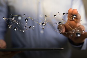 Abstract image of a network concept being connected and touched by a hand over a digital tablet, symbolizing co