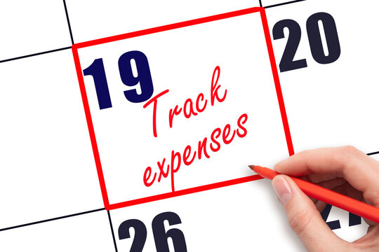 19 th day of the month. Hand writing Track expenses reminder and drawing red frame on calendar with red pen on white background. Business concept. Planning and scheduling