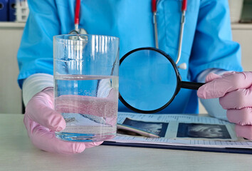 Healthcare professional examines water sample with magnifying glass in clinical ph,