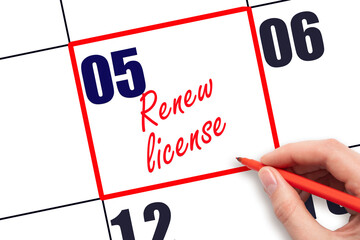 5 th day of the month. Hand writing Renew license reminder and drawing red frame on calendar with...