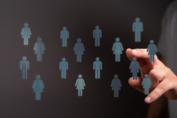 Hand reaching towards people icons representing human connection, social network, and teamwork in a digital wor