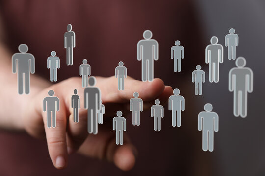 Concept of teamwork, communication, and collaboration through the touch of a hand with digital human icons. - Powered by Adobe