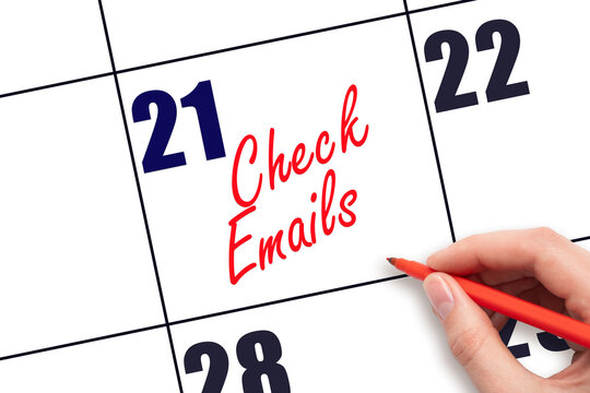 21 st day of the month. Hand writing Check emails reminder on calendar with red pen on white background. Business concept. Planning and scheduling