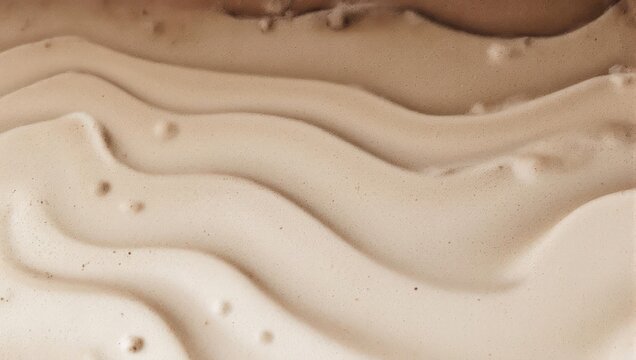 Abstract wavy pattern of various shades of brown and beige liquid foundation or paint.