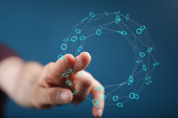 Hand reaching out to touch a glowing digital network sphere, representing connection, future tech and innovation. Blue background, high-tech abs