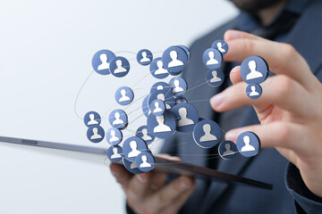 Person using a tablet to create a digital network, representing concepts of social media connections, networking, and online communities.