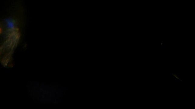 Abstract flare rainbow in black bg transition spreads across the white screen slow motion background