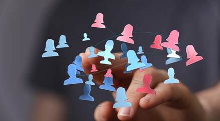 Networking concept of human silhouettes connected by lines with hand in foreground. Social...