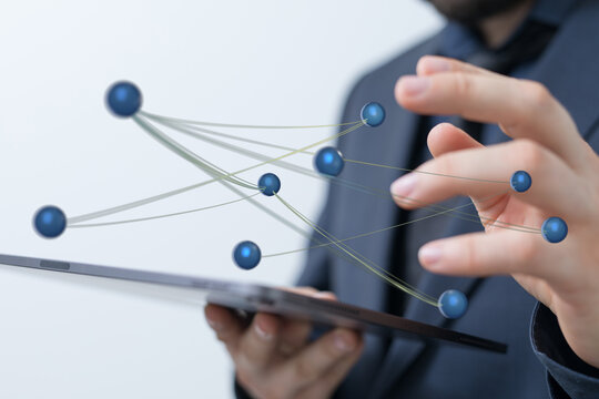 Business professional exploring global network connections and digital data flow with a tablet, symbolizing tea