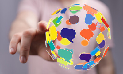 Hand reaching out to a globe of speech bubbles. Represents communication, social media, networking, and ideas in a digital world. Perfect for bl