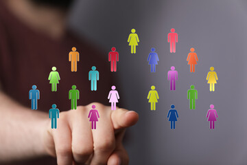 Abstract visual concept of a finger pointing towards a network of connected human figures, representing teamwork and unity in a collaborative di