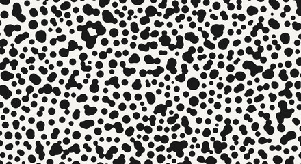 Abstract pattern of black dots and blobs on a white background.