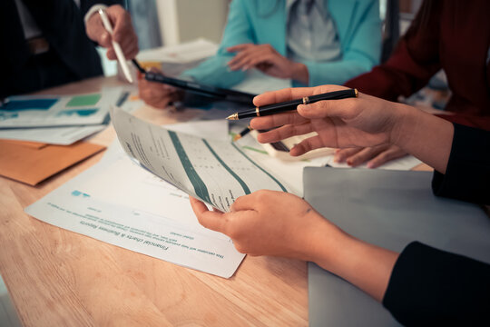 Businessman and team analyzing statistics with documents and graphs. Accounting consultant dealing with data, budget and profit chart for company. Close up.