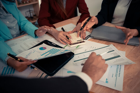 Businessman and team analyzing statistics with documents and graphs. Accounting consultant dealing with data, budget and profit chart for company. Close up.