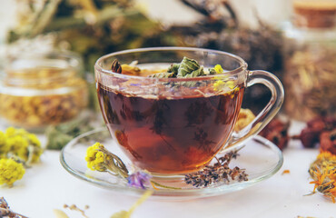 Herbal tea with medicinal herbs and flowers. Selective focus.