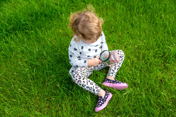 Child in nature with a lizard. Selective focus.