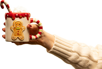 Hand holding gingerbread-themed holiday mug with candy cane and cream on transparent background. Concept of Christmas marketing, cozy lifestyle visuals, festive sweets, and warm emotional storytelling