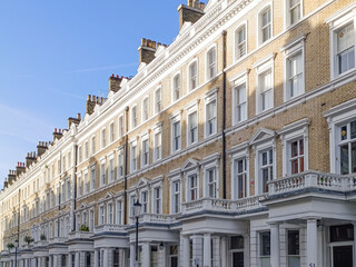 Elegant Victorian terraced townhouses in London with stucco columns and pastel facades