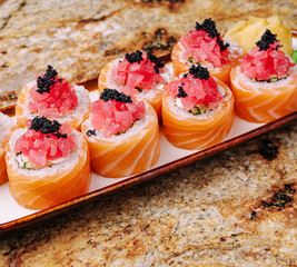 Delicious sushi rolls with fresh toppings served on a platter