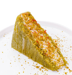 Delightful green cake slice topped with saffron strands and crushed nuts