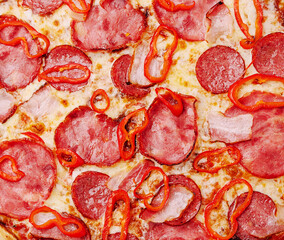 Delicious pizza topped with smoky ham and fresh red peppers
