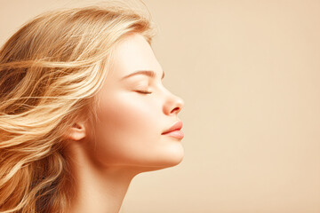 Fototapeta premium A serene portrait of a woman with closed eyes, showcasing flowing hair against a soft, neutral background, embodying calmness and beauty.