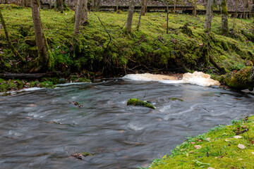 A long exposure view of water spilling over rapids, autumn landscape, November in nature, Ieriku mill, Latvia, fall
