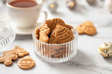 Christmas gingerbread cookies in glass bowl on festive  table with decorations against golden illumination. Merry Christmas