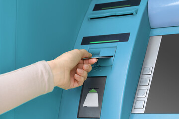Woman with bank card using modern cash machine, closeup. ATM
