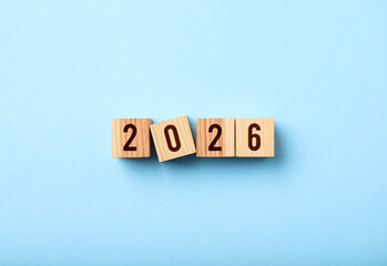 Obraz premium New 2026 year. Cubes with numbers on light blue background, top view