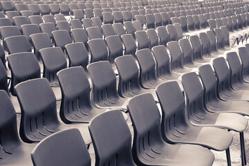 Naklejka premium Outdoor cinema with plastic chairs in a row without people