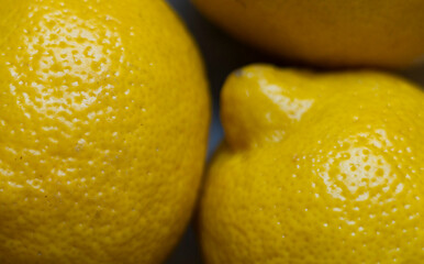 lemons on a black background, yellow demons are lying on the table, close-up