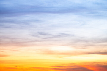 Sunset or sunrise sky with a vibrant gradient of orange, gold, and soft blue. Clear atmosphere with wispy clouds. Peaceful, natural light background. hope, freedom, new day and inspirational Concepts