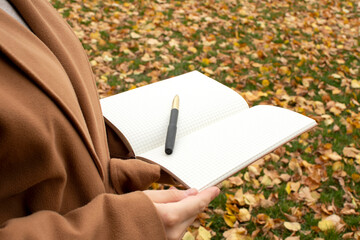 Woman holding a open notebook