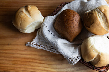 Wooden table with an assortment of freshly baked wholemeal and white breads. Copy space