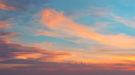 Soft peach and blue sky with wispy clouds at dusk sunset twilight