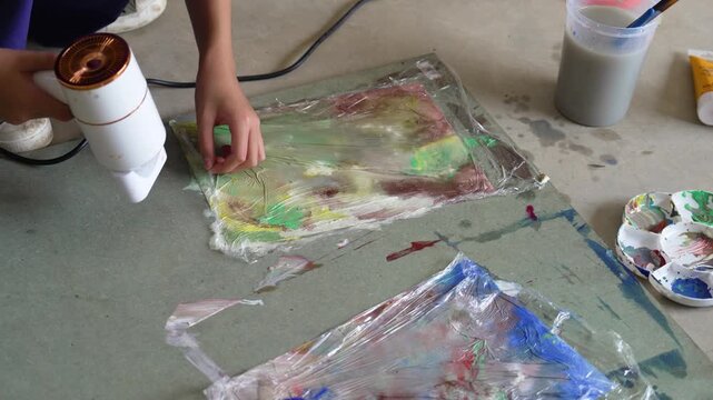 Children creating colorful watercolor paintings in art class activity