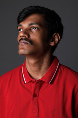 Fototapeta premium Portrait of Indian middleclass young man isolated on studio background. Close shot of confident Indian young man