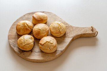 Traditional homemade british scones on wooden plank