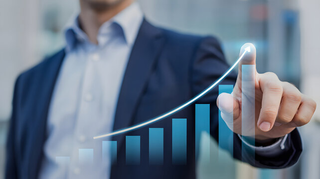 Businessman s hand touching a rising financial graph with upward trend and bar chart