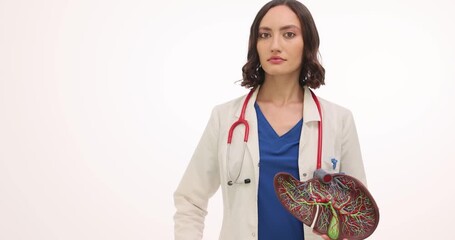 A dedicated medical professional emphasizes the importance of liver health. With a model of the liver in one hand and a drink in the other, she shares vital information in a clear manner.