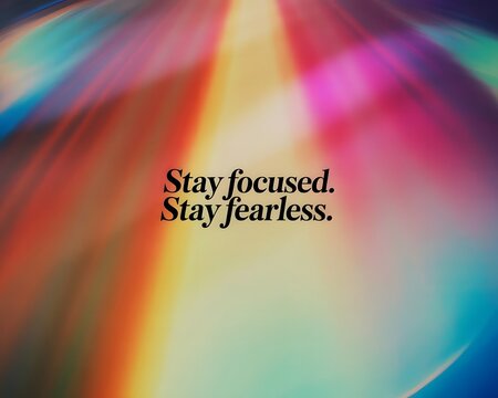 Inspirational quote stay focused stay fearless against colorful abstract light background