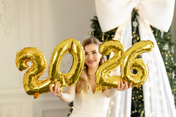 New Year 2026. Woman with balloons. Portrait of a beautiful smiling girl in a white suit. 2026 balloons
