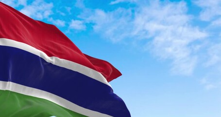 National flag of the Gambia waving in the wind on a clear day