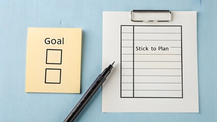 Flat arrangement of checklist and notes outlining a goal