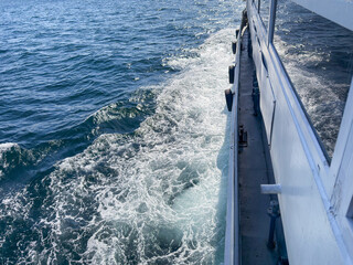 Detailed View from moving ferry boat showing waves and blue sea water